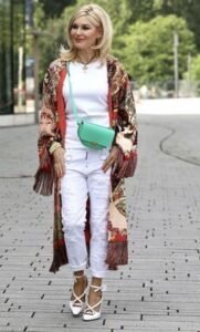 woman wearing white shirt and pants with printed long coat
